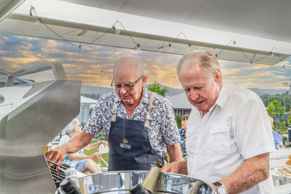 Men enjoying drinks and a BBQ at our Coffs Harbour retirement village.