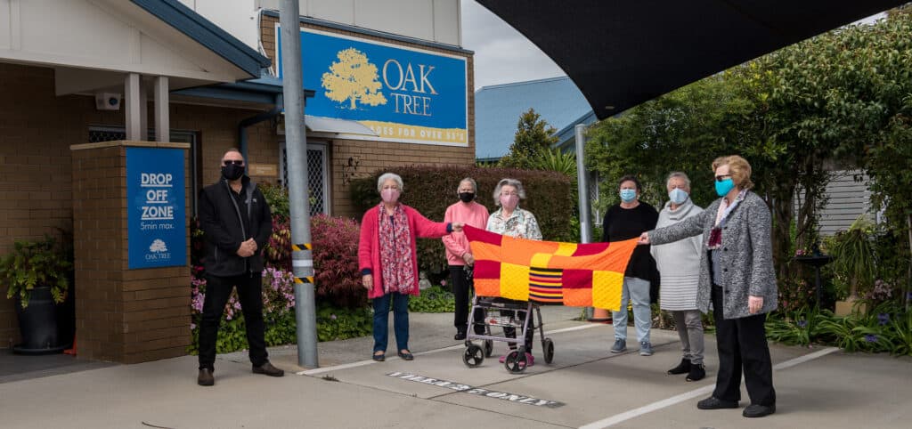 Oak Tree Skye residents showing off a blanket made during lockdown.